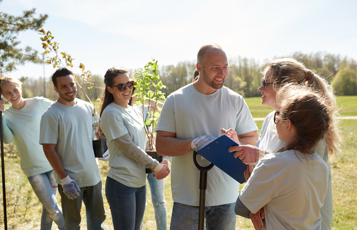 group-of-volunteers-with-tree-seedlings-in-park-PAVNZ5X